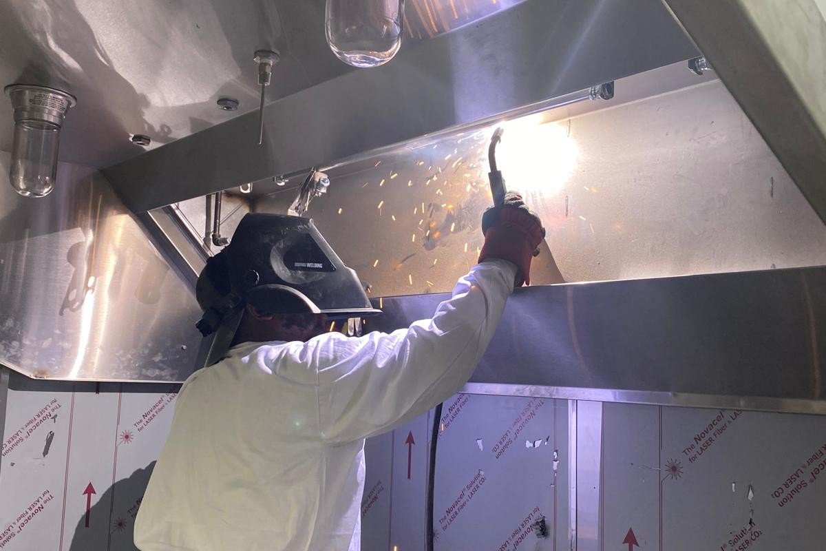 Technician working on commercial hood system